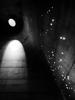 Interior of the Church of Saint-Pierre in Firminy. The sunlight through the roof projects the Constellation Orion on the walls. (1960–2006)