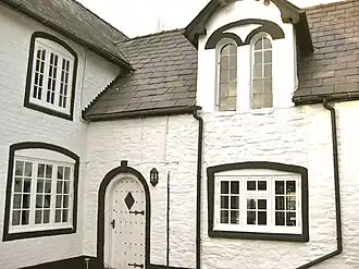 Victorian brick extension with arched dormer windows and arched doorway