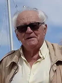Octagenarian caucasian male wearing sunglasses, in a marina