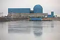 Modern plants have tended towards a design that is not completely cylindrical or spherical, like this containment within the blue painted reactor building of the Clinton Nuclear Generating Station.