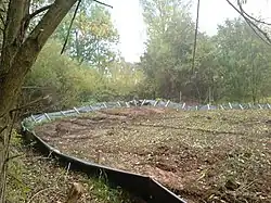 Low plastic fence around an area of recently upturned soil.