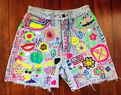 Image 58Acid washed jean shorts with grunge and hippie inspired DIY slogans and pictures. (from 1990s in fashion)