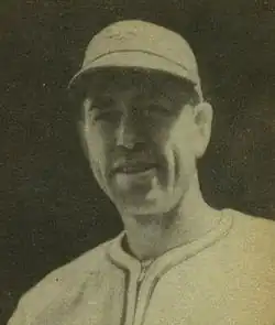 A man in a light baseball uniform