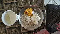 Dahi and chura served separately along with fruit