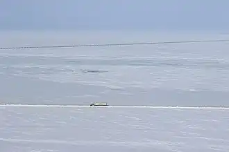 Aerial view of the highway with the Trans-Alaska Pipeline in the background (14 April 2015)