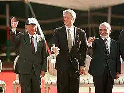 Clinton during the signing of the Israel–Jordan peace treaty, with Yitzhak Rabin (left) and King Hussein of Jordan (right)