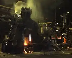Isengard is an "industrial hell":[2] in Tolkien's words "...hammers thudded. At night plumes of vapour steamed from the vents, lit from beneath with red light".[T 4] Steam hammer at work, England