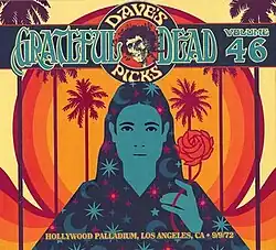 A woman holding a flower, with a sunset and palm trees in the background