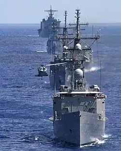 A SH-60 Seahawk helicopter preparing to land on the flight deck of USS&nbsp;Ingraham, leading the task force of Egyptian and Pakistan Navy during the Operation Bright Star in the Mediterranean Sea in 2005. Tariq is in the fourth row in front of USS&nbsp;Pearl Harbor, the last ship of this column.