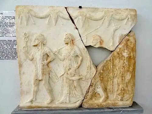 Ancient Greek festoons with bucrania on a relief with Hermes, Athena, Apollo and Artemis, 125-100 BC, marble, Archaeological Museum of Delos, Delos, Greece
