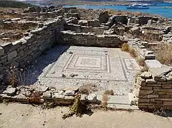 The ruins of a home with a mosaic floor