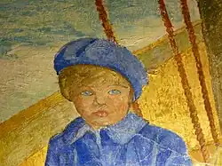 Bust-length view of small blue-eyed child in blue coat and cap sitting in boat