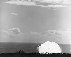 Shot Charlie, the second of three test explosions. USS Atlanta is moored to the left of the blast, with her bow pointing to the left