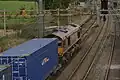 Diesel-hauled freight under the 25 kV wires on the West Coast Main Line at Cow Roast footbridge, near Tring
