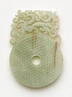 Disk (bi) with knobs, feline and dragon. Nephrite. Han dynasty, between 100 and 220 CE