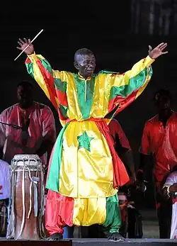 Doudou N'Diaye Rose on stage, in Senegalese-flag-patterned attire, 2014