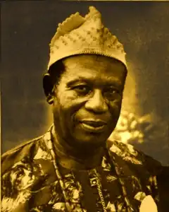 Clement Isong wearing a traditional cap
