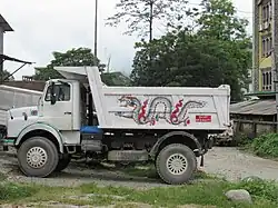 Small dump truck with a dragon painted on the side
