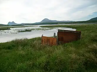 A duck blind on Loch Urigill. A swampy inlet at the head of Loch Urigill. Suilven and Canisp on the horizon.