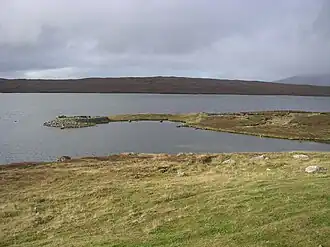 An upland lake surrounded by rough grassland
