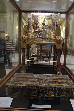 Ornate golden throne chair with intricate Egyptian decorative elements