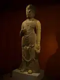 Guanyin, overwhelmed by the cries of the faithful, split her head open and grew ten extra faces, to better hear the cries, and this statue depicts Guanyin with eleven faces.