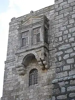 A bay window on a stone wall