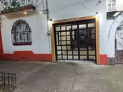 A sidewalk leading to the entrance of a café