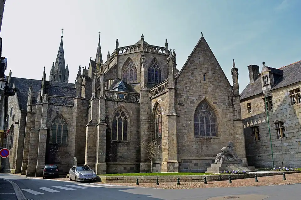 View of the east end of the cathedral in daylight. Note the evocative war memorial in front of the chevet.