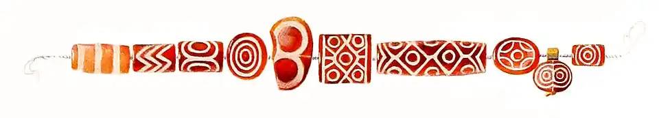 Etched carnelian beads excavated in the Royal Cemetery of Ur, tomb PG 1133, 2600–2500 BCE.[87]