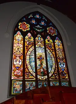 Large window in rear wall of sanctuary