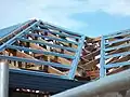 Metal purlins or roof battens screwed to roof gang-nail-type trusses