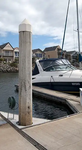A floating dock at a private marina. The vertical "spud" only anchors the dock sections in place, and does not provide structural support for loads upon the dock.