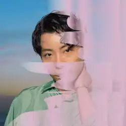 The cover art to "Fushigi" / "Create". It features Hoshino in a light green button-up shirt above a dawn background. A transparent light purple paint, like that of the clouds in the background, partly cover the screen from right to left.