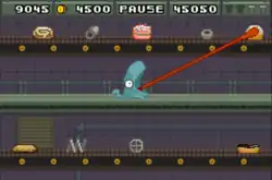 Gameplay screenshot of a dinosaur extending its tongue towards a pastry on a conveyor belt.
