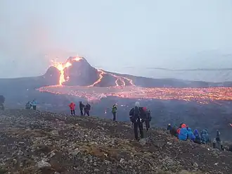 People on the slopes of Fagradalsfjall, watching the Geldingadalir eruption