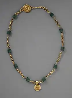 Necklace with a medallion depicting a goddess; 30–300 AD; green glass (the green beads) and gold; length: 43.82 centimetres (17.25 in); Los Angeles County Museum of Art