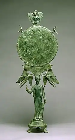 Fancy Early Classical bronze mirror with human caryatid handle, c. 460 BC