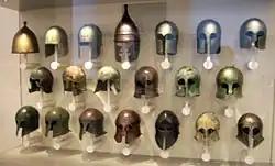 Types of Ancient Greek helmets; top line, third from the left: Greco-Illyrian type helmet. Antikensammlung in Altes Museum, Berlin.