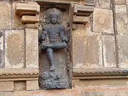 Dakshinamurti portrayed as the teacher of yoga, dance and sciences stepping over demon of ignorance.[48]