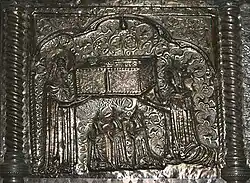 A lady and three girls pray on their knees before a bearded man