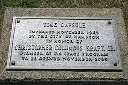 Metal plaque which reads: Time capsule interred November 1965 by the city of Hampton in honor of Christopher Columbus Kraft Jr. pioneer of U.S. space program to be opened November 2065