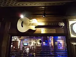 A golden guitar on the wall