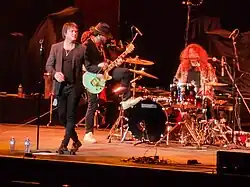 Harm & Ease performing in 2023; left to right, Rylan Whalen (vocals), Danny Lopez (guitar), and Alex Hamnett (drums)