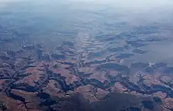 Oblique air photo of the canyon of Havasu Creek flowing into the Colorado River in the foreground