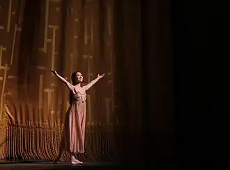 Photograph of Seo with her arms out during the curtain call for Romeo and Juliet on 19 June 2015