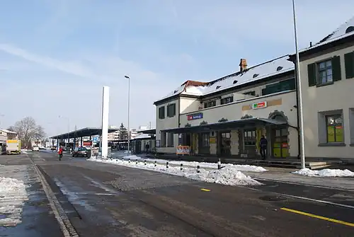 Two-story white building with black slanted roof