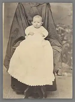 Mother well hidden by long overcoat