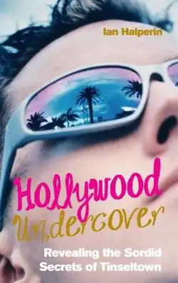 Cover has a close up of a man's face, with palm trees and a sunset reflected in the lens of his dark glasses