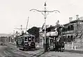 1909 : In North Terrace, a "toast rack" electric tram passes a horse tram running a service until its line was upgraded.